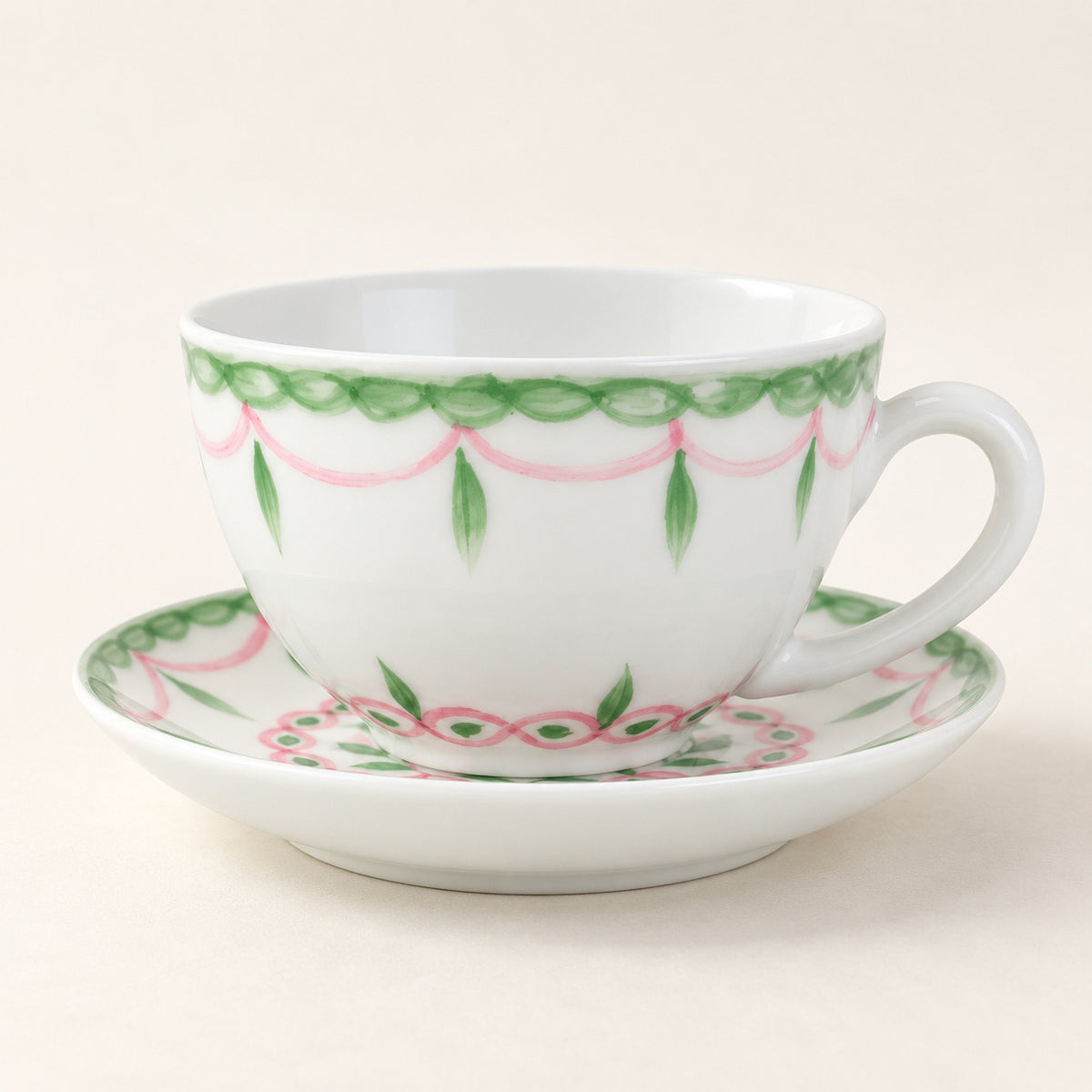 AI-assisted concept image of a white cup and saucer with pink swags and green leaf details.