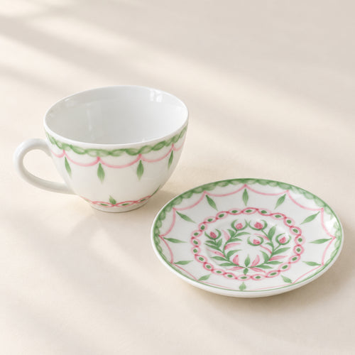 AI-assisted concept image showing the botanical cup beside its matching floral saucer.