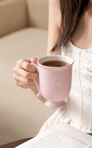Fuyu Butterfly Bud Mug — Blush Pink — styled use illustration; props and additional pieces excluded 8; AI-assisted image