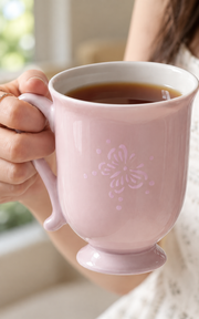 Fuyu Butterfly Bud Mug — Blush Pink — styled use illustration; props and additional pieces excluded 9; AI-assisted image