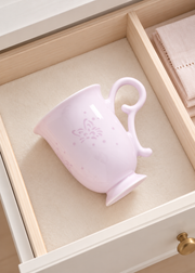 Fuyu Butterfly Bud Mug — Blush Pink — styled use illustration; props and additional pieces excluded 12; AI-assisted image