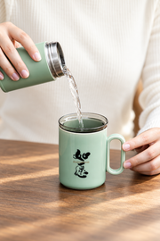 ZhangHongJi Celadon Infuser Mug — styled use illustration; props and additional pieces excluded 7; AI-assisted image