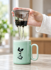 ZhangHongJi Celadon Infuser Mug — styled use illustration; props and additional pieces excluded 8; AI-assisted image