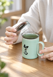 ZhangHongJi Celadon Infuser Mug — styled use illustration; props and additional pieces excluded 9; AI-assisted image