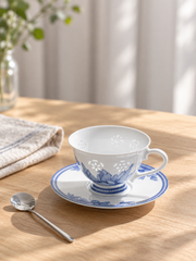 Fuyu Lotus Cup & Saucer — Cobalt Blue — styled use illustration; props and additional pieces excluded 8; AI-assisted image