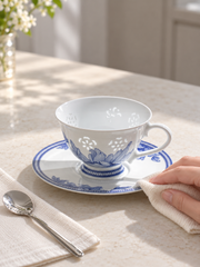 Fuyu Lotus Cup & Saucer — Cobalt Blue — styled use illustration; props and additional pieces excluded 11; AI-assisted image