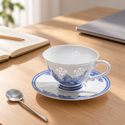 Fuyu Lotus Cup & Saucer — Cobalt Blue — styled use illustration; props and additional pieces excluded 12; AI-assisted image
