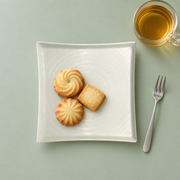 DXC Crystal White Square Plate — styled use illustration; props and additional pieces excluded 10; AI-assisted image