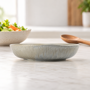 DXC Mist Gray Deep Serving Plate — styled use illustration; props and additional pieces excluded 10; AI-assisted image