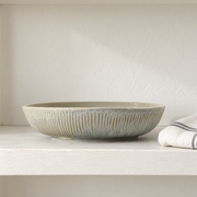 DXC Mist Gray Deep Serving Plate — styled use illustration; props and additional pieces excluded 12; AI-assisted image