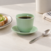 Loveramics Green Tasting Cup & Saucer — styled use illustration; props and additional pieces excluded 7; AI-assisted image