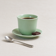 Loveramics Green Tasting Cup & Saucer — styled use illustration; props and additional pieces excluded 9; AI-assisted image