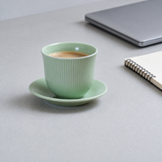 Loveramics Green Tasting Cup & Saucer — styled use illustration; props and additional pieces excluded 10; AI-assisted image