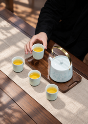 Fuyu Qingbai Linglong Tea Set — Teapot & Four Cups — styled use illustration; props and additional pieces excluded 8; AI-assisted image