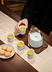 Fuyu Qingbai Linglong Tea Set — Teapot & Four Cups — styled use illustration; props and additional pieces excluded 11; AI-assisted image