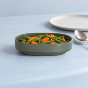Loveramics Tapas Oval Bowl — Dark Green — styled use illustration; props and additional pieces excluded 8; AI-assisted image