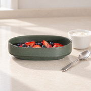 Loveramics Tapas Oval Bowl — Dark Green — styled use illustration; props and additional pieces excluded 9; AI-assisted image