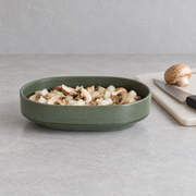 Loveramics Tapas Oval Bowl — Dark Green — styled use illustration; props and additional pieces excluded 10; AI-assisted image