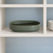 Loveramics Tapas Oval Bowl — Dark Green — styled use illustration; props and additional pieces excluded 12; AI-assisted image