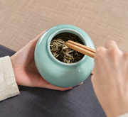 Shang Tang Rounded Celadon Tea Canister — styled use illustration; props and additional pieces excluded 7; AI-assisted image