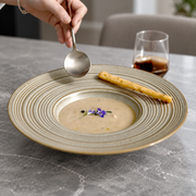 DXC Gray-Olive Ringed Deep Plate — styled use illustration; props and additional pieces excluded 7; AI-assisted image
