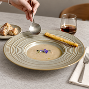 DXC Gray-Olive Ringed Deep Plate — styled use illustration; props and additional pieces excluded 8; AI-assisted image