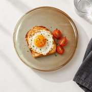 DXC Cream Reactive-Glaze Dinner Plate — styled use illustration; props and additional pieces excluded 10; AI-assisted image