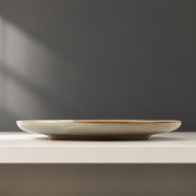 DXC Cream Reactive-Glaze Dinner Plate — styled use illustration; props and additional pieces excluded 12; AI-assisted image