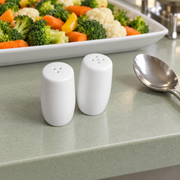 Rollin White Salt & Pepper Shakers — Pair — styled use illustration; props and additional pieces excluded 9; AI-assisted image