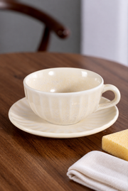 SONGFA Oatmeal Fluted Cup & Saucer — styled use illustration; props and additional pieces excluded 12; AI-assisted image