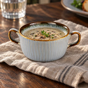 AI-assisted illustration of Mist Blue Double-Handled Soup Cup, mushroom supper setting; food and styling props are not included.