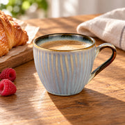 AI-assisted illustration of Mist Blue Ribbed Coffee Cup, coffee breakfast setting; food and styling props are not included. Saucer is not included.