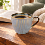 AI-assisted illustration of Mist Blue Ribbed Coffee Cup, reading pause setting; food and styling props are not included. Saucer is not included.