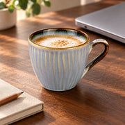 AI-assisted illustration of Mist Blue Ribbed Coffee Cup, desk coffee setting; food and styling props are not included. Saucer is not included.