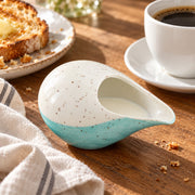 AI-assisted illustration of Lagoon Handleless Creamer, coffee breakfast setting; food and styling props are not included.