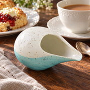 AI-assisted illustration of Lagoon Handleless Creamer, afternoon tea setting; food and styling props are not included.