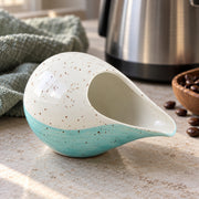 AI-assisted illustration of Lagoon Handleless Creamer, kitchen counter setting; food and styling props are not included.