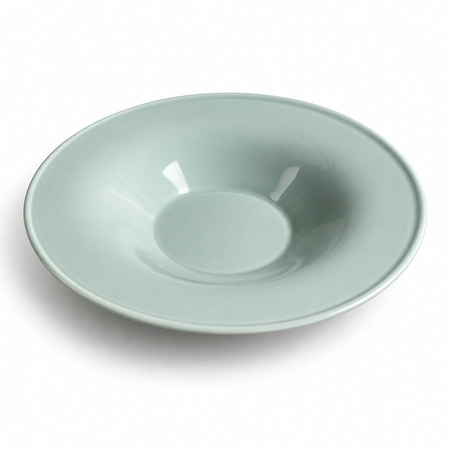 AI-assisted illustration of Sage Wide-Rim Pasta Plate, angled catalog view.