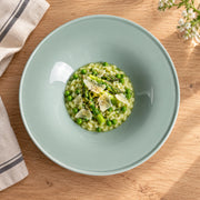 AI-assisted illustration of Sage Wide-Rim Pasta Plate, spring risotto setting; food and styling props are not included.