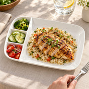 AI-assisted illustration of Ivory Four-Compartment Plate, weekday lunch setting; food and styling props are not included.