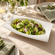 AI-assisted illustration of Ivory Swept-Corner Serving Dish, salad table setting; food and styling props are not included.