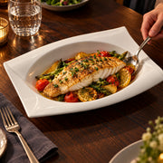 AI-assisted illustration of Ivory Swept-Corner Serving Dish, fish dinner setting; food and styling props are not included.