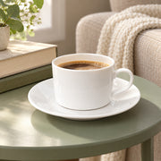 AI-assisted illustration of Ivory Cylinder Cup & Saucer, reading break setting; food and styling props are not included.