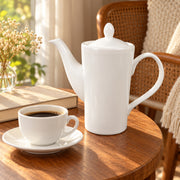 AI-assisted illustration of Ivory Lidded Coffee Pot, reading pause setting; food and styling props are not included.