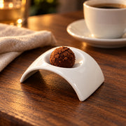 AI-assisted illustration of Ivory Arch Appetizer Dish, chocolate bite setting; food and styling props are not included.