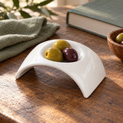 AI-assisted illustration of Ivory Arch Appetizer Dish, olive snack setting; food and styling props are not included.