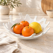 AI-assisted illustration of Coral-Rim White Serving Bowl, citrus centerpiece setting; food and styling props are not included.