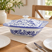 AI-assisted concept image of cobalt botanical lidded server: styled setting view; food and props are not included.