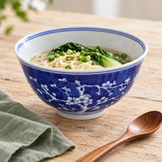 AI-assisted concept image of cobalt plum blossom deep bowl: styled setting view; food and props are not included.