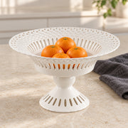 AI-assisted concept image of ivory openwork pedestal compote: styled setting view; food and props are not included.